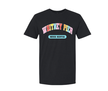 A black short-sleeve crewneck t-shirt featuring a colorful graphic on the chest that reads 'WHITNEY PIER' in rainbow-colored letters with 'NOVA SCOTIA' underneath in a light blue oval, displayed on a solid white background.