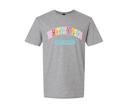 A heather grey short-sleeve t-shirt with a colourful graphic on the chest reading 'WHITNEY PIER' in pastel rainbow letters and a light blue banner below reading 'NOVA SCOTIA'.